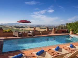 a swimming pool with chairs and an umbrella at Villa La Veduta by Interhome in Molino Mazzetti +22 photos