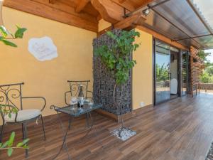 a living room with a table and a plant at Chalet Il Vitigno by Interhome in Sutri