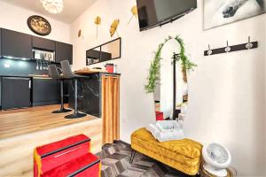 a living room with a couch and a table at Le Cupidon, En plein Coeur de Lorient in Lorient +3 photos