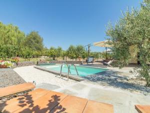 a swimming pool in a yard with a bench at Chalet Il Vitigno by Interhome in Sutri