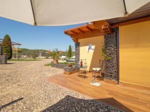 a patio of a house with a wooden deck at Chalet Il Vitigno by Interhome in Sutri +19 photos