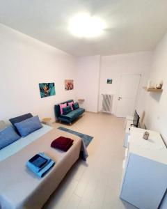 a bedroom with a large bed and a couch at Alloggio Vimercati 45 in Rome