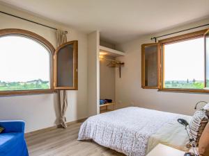 a bedroom with two large windows and a bed at Holiday Home Il Venturino by Interhome in Fucecchio