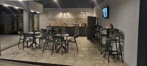 Un restaurante con mesas y sillas y una cocina. en CHG Boutique, en Costinesti