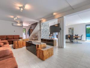 a living room with a couch and a tv at Villa Rial 2 by Interhome in Fažana