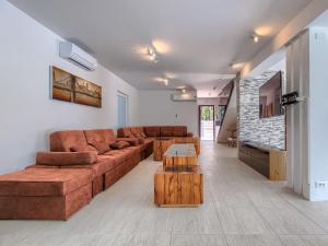 a living room with a brown couch and wooden tables at Villa Rial 2 by Interhome in Fažana +51 photos