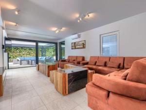 a living room with a couch and a table at Villa Rial 2 by Interhome in Fažana