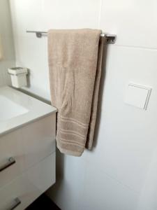 a towel hanging on a towel rack in a bathroom at Apartamento nuevo Playa aislada Primera línea de playa in Cullera +28 photos