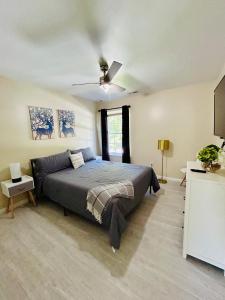a bedroom with a bed and a ceiling fan at Cozy Bedroom Suites in Beautiful Shared Home in Matthews