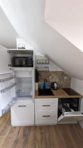 a kitchen with white cabinets and a counter top at Guest House Gacka Rogić in Otočac