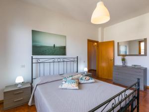 a bedroom with a bed with two pillows on it at Apartment Casa di Neva by Interhome in Marina di Cecina