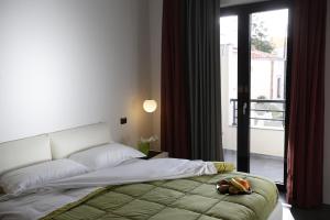 a bedroom with a bed with a stuffed animal on it at Le Formiche in Milazzo