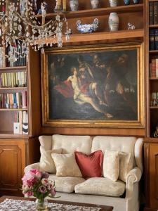 a couch in a living room with a painting on the wall at Genoa view & hiking in italian riviera in Genoa