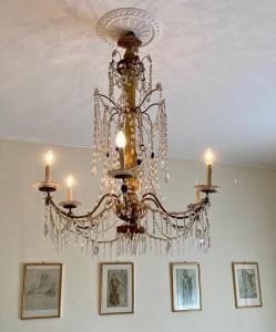 a chandelier hanging from a ceiling with pictures at Genoa view & hiking in italian riviera in Genoa