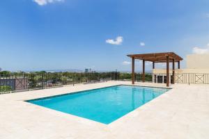 a swimming pool with a gazebo on top of a building at Choose To Be Happy at Twenty 2A 2-Bedroom w Pool in Kingston