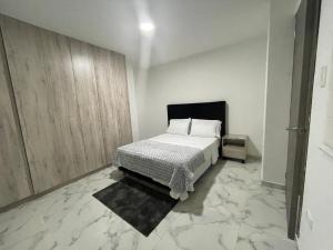 a bedroom with a bed and a marble floor at La Roca 101 in Cali