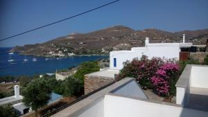 a view from the balcony of a house with flowers at Serenity Maisonnette in Otzias