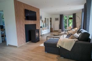 a living room with a couch and a fireplace at Chez Jojo - Gîte rural in Spa