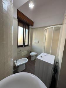a bathroom with a toilet and a sink at Luxury flat on the heart of Reggio Calabria in Reggio Calabria +7 photos