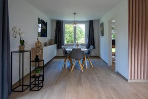 a dining room with a table and a window at Chez Jojo - Gîte rural in Spa
