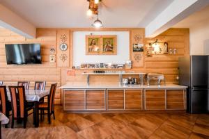 a kitchen with a table and a refrigerator at Willa Stołowianka- Basen in Bukowina Tatrzańska