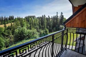 a balcony of a building with a view of trees at Willa Stołowianka- Basen in Bukowina Tatrzańska