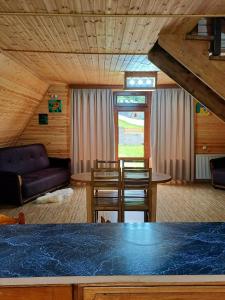 a living room with a table and a couch at Forest hut in Borjomi +26 photos