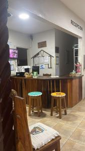a waiting room with two tables and a counter at Hotel La Casona de Don Pepe in Roboré