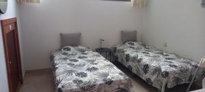 deux lits côte à côte dans une pièce dans l'établissement Duplex Anfi Topaz, à Mogán 55 autres photos