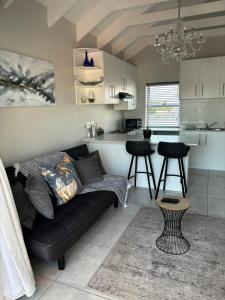 a living room with a couch and a kitchen at Shanty's Rest in Velddrif