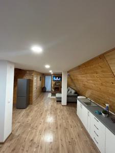 a large living room with wooden walls and wooden floors at Cazare la mare Cabana Alina in Papuci