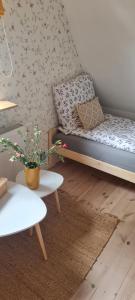 a living room with a couch and a table at Malinowa Chata- Królowy Most in Królowy Most
