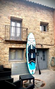 a surfboard is hanging on the side of a building at La Casa Rural de Pálmaces in Pálmaces de Jadraque