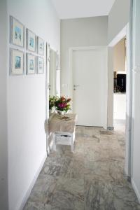 un corridoio con pareti bianche e pavimento in pietra di Casa Lux ampio monolocale ad Alassio Altre 20 foto
