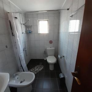 a small bathroom with a toilet and a sink at Makri Vacation House in Alexandroupoli +9 photos