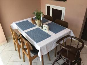 a table with a blue and white table cloth on it at Rose house in Olib