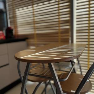 a wooden table and two chairs in a kitchen at Seanest Greencoast in Himare +7 photos