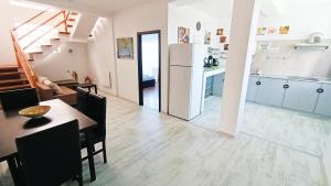 a kitchen and living room with a table and a kitchen and a dining room at Portofino Villa in Costinesti