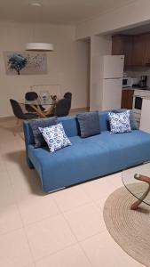 a blue couch sitting in a living room at Limpi's Cozy Place -Modern Apartment Near Mystras & Sparta Center in Sparta
