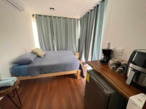 a small bedroom with a bed and a television at XpuHa Bonanza in Xpu Ha