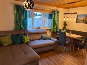 a living room with a couch and a table at Ferienhaus Romantika in Bad Aussee