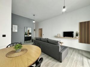 a living room with a couch and a table at Bamboo House Syros 2 in Ermoupoli