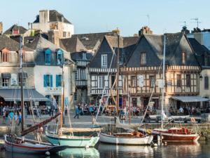 a group of boats docked in a harbor with buildings at Plouharnel-Carnac-Quiberon bord de mer in Plouharnel