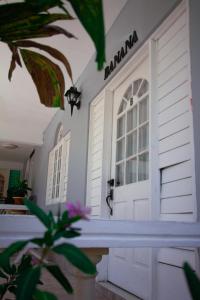 a house with a white door and a plant at Match Resort in Port Antonio