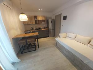 a living room with a couch and a kitchen at House Karga in Ormos Panagias +36 photos
