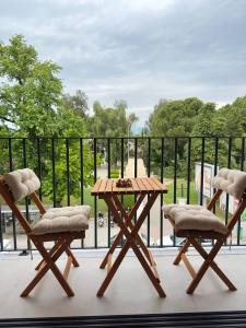 a wooden table and two chairs on a balcony at Rue Rooms in Fethiye