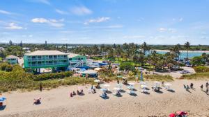 an aerial view of a beach with chairs and umbrellas at Ocean View Hotel Room with Balcony- King Bed #19 in Fort Pierce