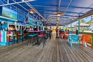a restaurant with colorful tables and chairs on a pier at Ocean View Hotel Room with Balcony- King Bed #19 in Fort Pierce