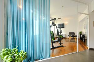 a room with a hair salon with blue curtains at Eco Hotel Cleofe in Caorle