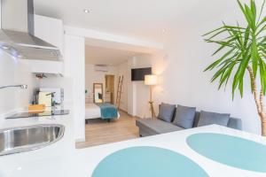 a room with a sink and a living room with a couch at Malabau Beach House in Tarifa